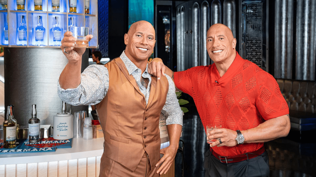 Dwayne "The Rock" Johnson standing next to his wax figure at Madame Tussauds Las Vegas