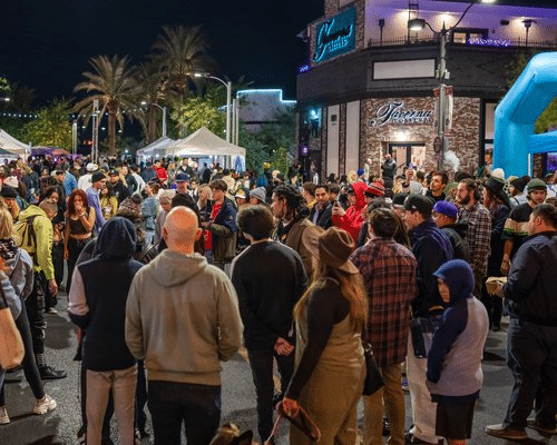 Crowd of people walking through the arts district in Fremont Street for First Friday